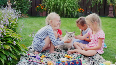 Children-Play-With-A-Cat-In-The-Yard