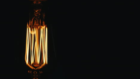 Längliche-Vintage-Lampe-Edison-Schaltet-Langsam-Einen-Schwarzen-Hintergrund-Ein-Prores-Hq-422-10-Bit-Video