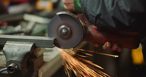 Steel-Industry-Man-Using-Angle-Grinder-Grinding-Metal-Object-