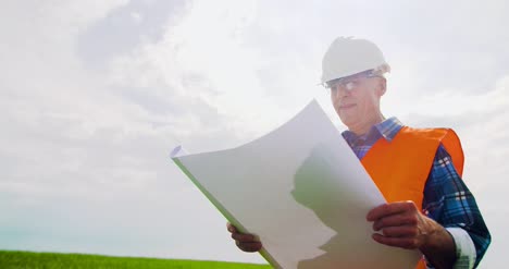 Engineer-Analyzing-Plan-While-Looking-At-Windmill-Farm-Eco-Energy-Concept-14