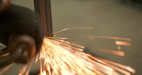 Steel-Industry-Man-Using-Angle-Grinder-Grinding-Metal-Object-3