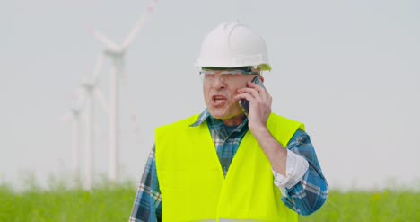 Frustrated-Male-Engineer-Talking-On-Phone-At-Farm