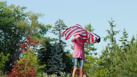 Emotions-With-Usa-Flag---Young-Woman-Jumping-Holding-A-Flag-In-Her-Hands-Independence-Day-And-A-Trip