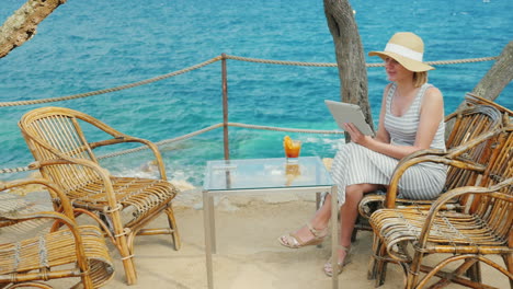 Holidays-On-A-Tropical-Resort-Always-Connected-Woman-Talking-With-The-Tablet