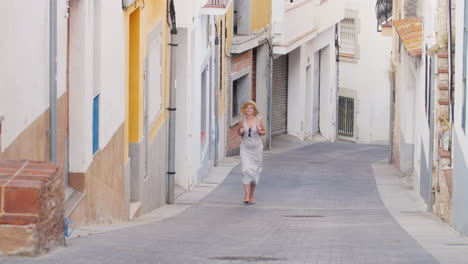 Woman-Tourist-Is-Vverhpo-Narrow-Street-In-The-Old-Quarter-Of-The-Old-City-Lloret-De-Mar-Spain-Touris