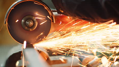 Industry-Worker-Grinding-Metal-With-Angle-Grinder-1