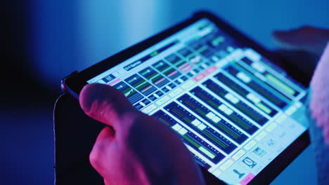 A-Professional-Sound-Engineer-Uses-A-Tablet-Near-The-Stage-Controls-The-Sound-Of-The-Music-Group-Hd-