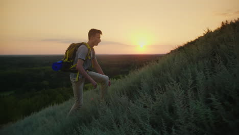 The-Guy-The-Teenager-With-A-Backpack-Climbs-Up-The-Mountain-At-Sunset-Active-Way-Of-Life-Since-Youth