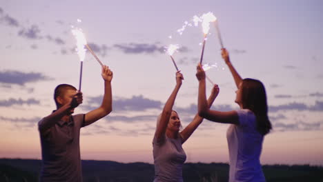 Friends-Have-Fun-In-Fireworks-Through-After-The-Sunset-A-Beach-Party