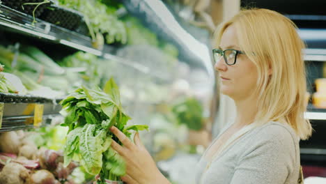 Young-Woman-Carefully-Chooses-Lettuce-In-The-Store-Healthy-Lifestyle-And-Proper-Nutrition