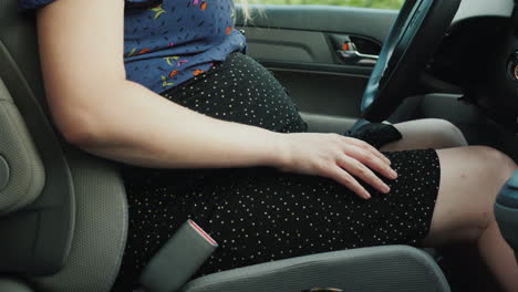 Pregnant-Woman-Car-Driver-Fastens-Seat-Belt