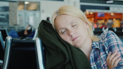 Tired-Passenger-Sleeps-In-Airport-Terminal-While-Waiting-For-His-Flight