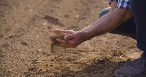 Farmer-Hands-Holding-And-Pouring-Back-Organic-Soil-