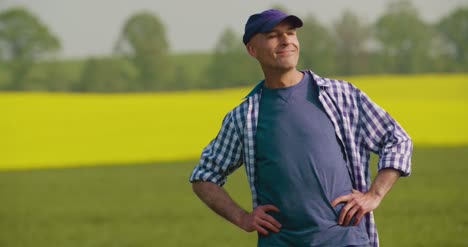 Smiling-Mature-Farmer-Examining-Agricultural-Field-1