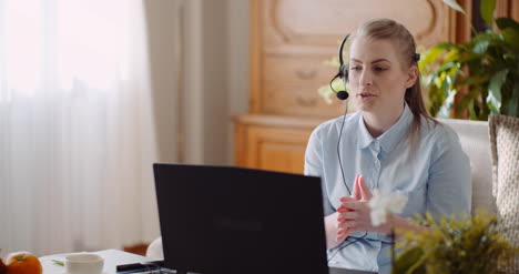 Sales-Representative-In-Headset-Speaking-To-Client-And-Making-Video-Conference-Call-On-Laptop-5