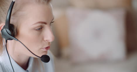 Sales-Representative-In-Headset-Speaking-To-Client-And-Making-Video-Conference-Call-On-Laptop-8