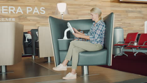 The-Passenger-Uses-The-Entertainment-Terminal-Sits-In-A-Comfortable-Chair