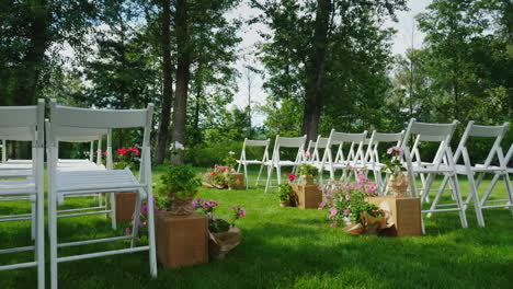 Green-Lawn-With-Rows-Of-White-Wooden-Chairs-Place-For-The-Wedding-Ceremony