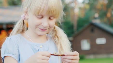 A-6-Year-Old-Girl-Looks-At-A-Small-Snail-In-Her-Hands-Concept---Communication-With-Nature-Life-Aroun