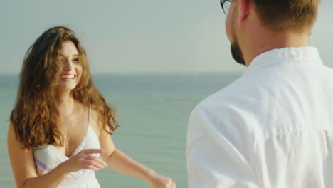 Young-Woman-With-Her-Husband-Dancing-On-The-Beach