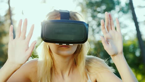 Young-Woman-In-A-Helmet-Of-Virtual-Reality-Touching-Invisible-Wall