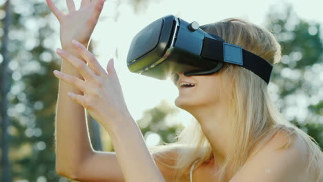 Young-Woman-In-A-Helmet-Of-Virtual-Reality-Touching-Invisible-Wall