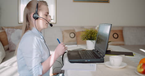 Sales-Representative-In-Headset-Speaking-To-Client-And-Making-Video-Conference-Call-On-Laptop-12