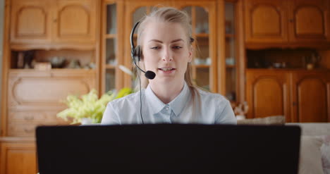 Sales-Representative-In-Headset-Speaking-To-Client-And-Making-Video-Conference-Call-On-Laptop-3
