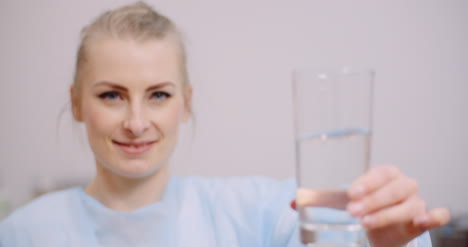 Extreme-Close-Up-Of-Female-Doctor-Drinking-Glass-Of-Water-4