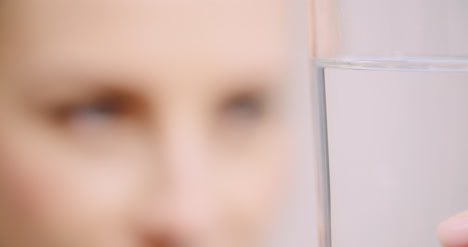 Extreme-Close-Up-Of-Woman-Looking-At-Glass-Of-Water
