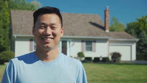 Portrait-Of-A-Happy-Asian-Man-On-The-Background-Of-A-New-Home-Looking-At-The-Camera-Smiling-Successf