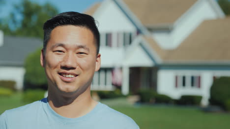 Portrait-Of-A-Happy-Asian-Man-On-The-Background-Of-A-New-Home-Looking-At-The-Camera-Smiling-Successf