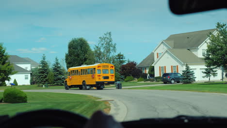 View-From-The-Window-Of-The-Car-Which-Goes-After-The-School-Yellow-School-Bus-In-The-Us-Suburb