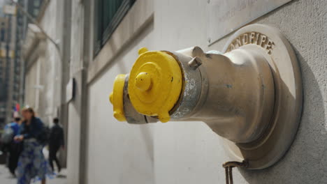 Fire-Hydrant-In-The-Wall-Of-A-Building-On-Wall-Street-In-New-York
