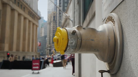Fire-Hydrant-In-The-Wall-Of-A-Building-On-Wall-Street-In-New-York