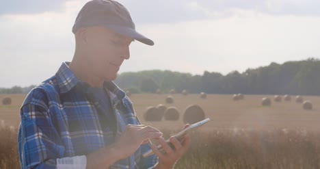 Farmer-Using-Digital-Tablet-At-Farm-6