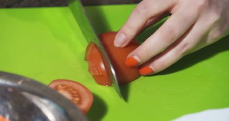 Slicing-Tomato-In-Kitchen