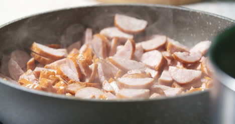 Sausage-Cuts-Frying-On-Pan-1