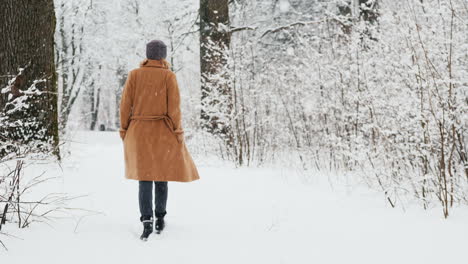 Stylish-Middle-Aged-Woman-Walks-In-Snow-Park