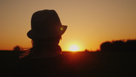 A-Woman-In-A-Hat-Looks-Forward-To-The-Sunset-Hope-And-Bright-Future-Concept-4K-Slow-Motion-Video