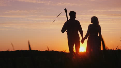 A-Family-Of-Farmers-Enjoying-The-Sunset-In-The-Field-A-Man-Is-Holding-A-Scythe-Next-To-Him-Is-His-Wi