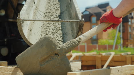Pour-Concrete-From-The-Mixer-Into-The-Formwork-In-The-Background-Blurred-New-Buildings-Construction-