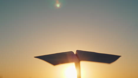 A-Paper-Airplane-Is-Flying-In-The-Sky-To-Meet-The-Setting-Sun