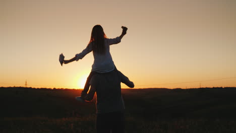 Happy-Father-Playing-With-His-Daughter-At-Sunset