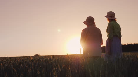 Two-Women---Mother-And-Daughter-Look-At-The-Beautiful-Sunset-Over-The-Wheat-Field