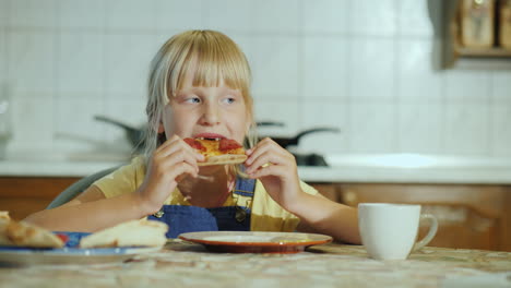 A-Little-Girl-With-An-Appetite-Eating-Pizza-In-The-Kitchen-4K-Video
