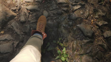 A-Man-In-Trekking-Boots-Walks-Along-A-Slippery-Stony-Path-In-The-Forest-First-Person-Video-Hiking-An