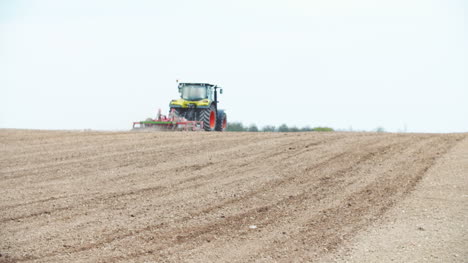 Tractor-Plowing-Field-Using-Harrows-(Wide-Shoot)