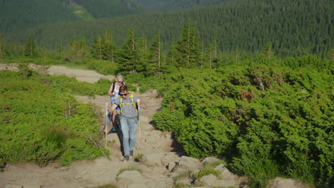 A-Couple-Of-Travelers-With-Backpacks-Go-Up-The-Mountain-Path-4K-Video