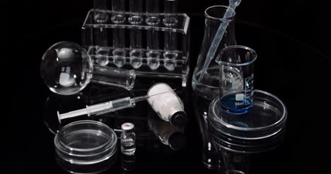 Laboratory-Equipement:-Syringe-And-Medicine-Test-Tubes-And-Flasks-Rotating-On-Black-Background-6